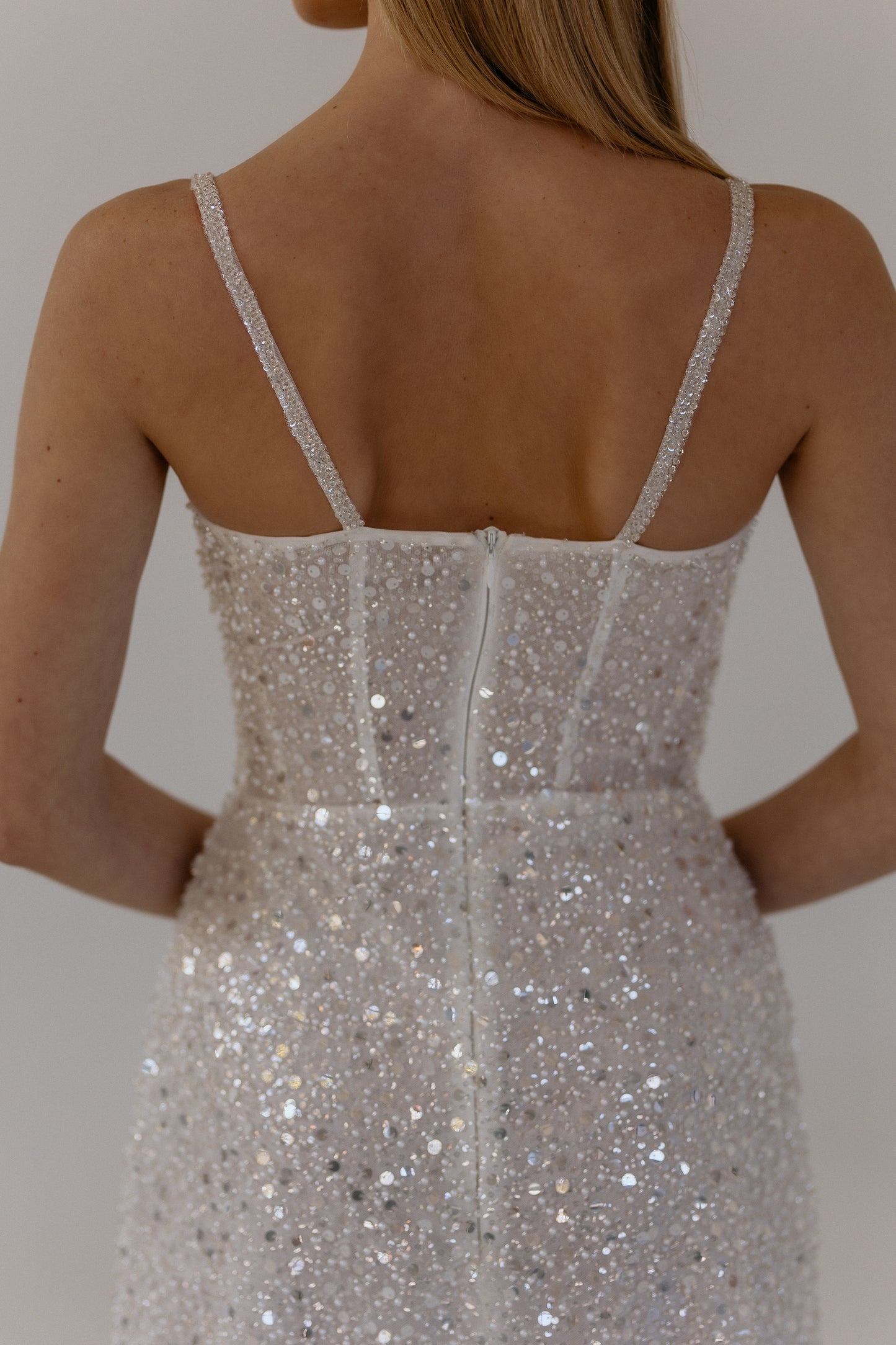 Celia white mini wedding dress close back view showing straps and fabric detais, perfect for bridal shower and wedding party celebrations