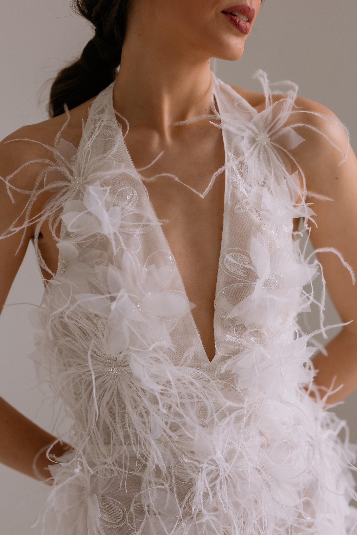 wedding reception dress Lillian detail view showing stunning fabric details such as feathers, 3-D flowers and beads, perfect for rehearsal dinner or engagement party