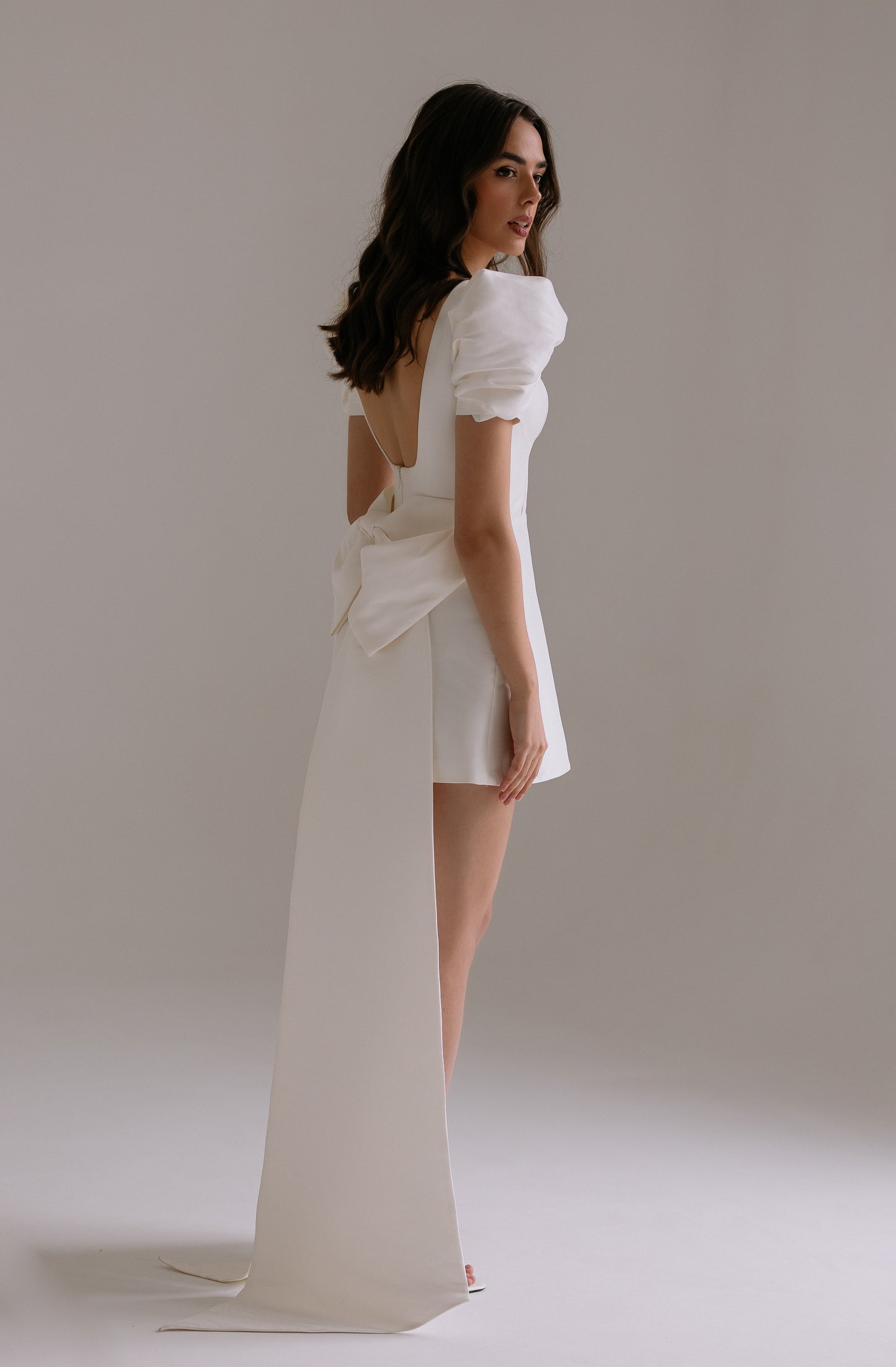 Leonie dress statement bow detail side view showing dramatic train