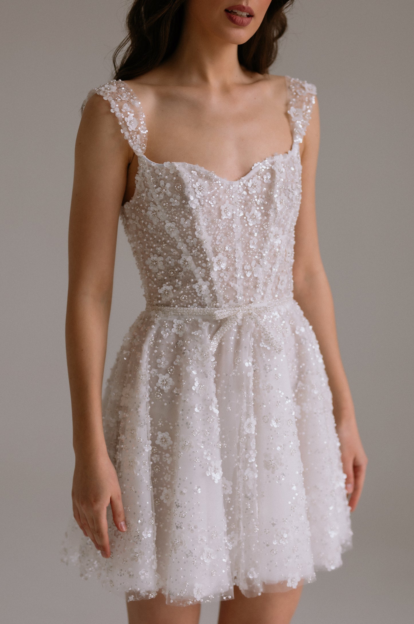 Carrie wedding reception dress detail view showing beautiful elements of the bodice design. Perfect as engagement dress, after party wedding dress or bridal shower dress.