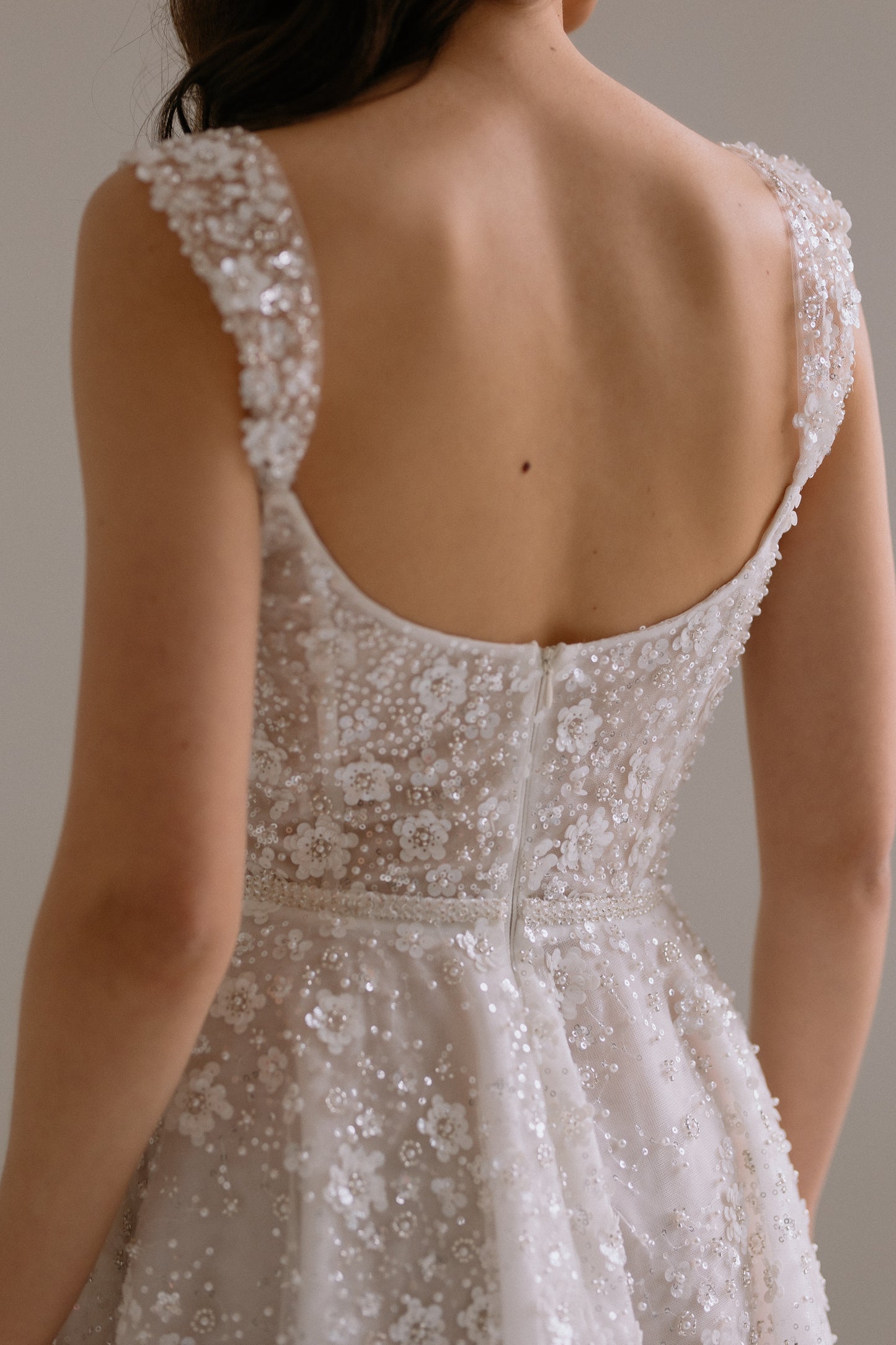 Carrie wedding reception dress detail view of the back showing beautiful design details and straps. Perfect as engagement dress, after party wedding dress or bridal shower dress.