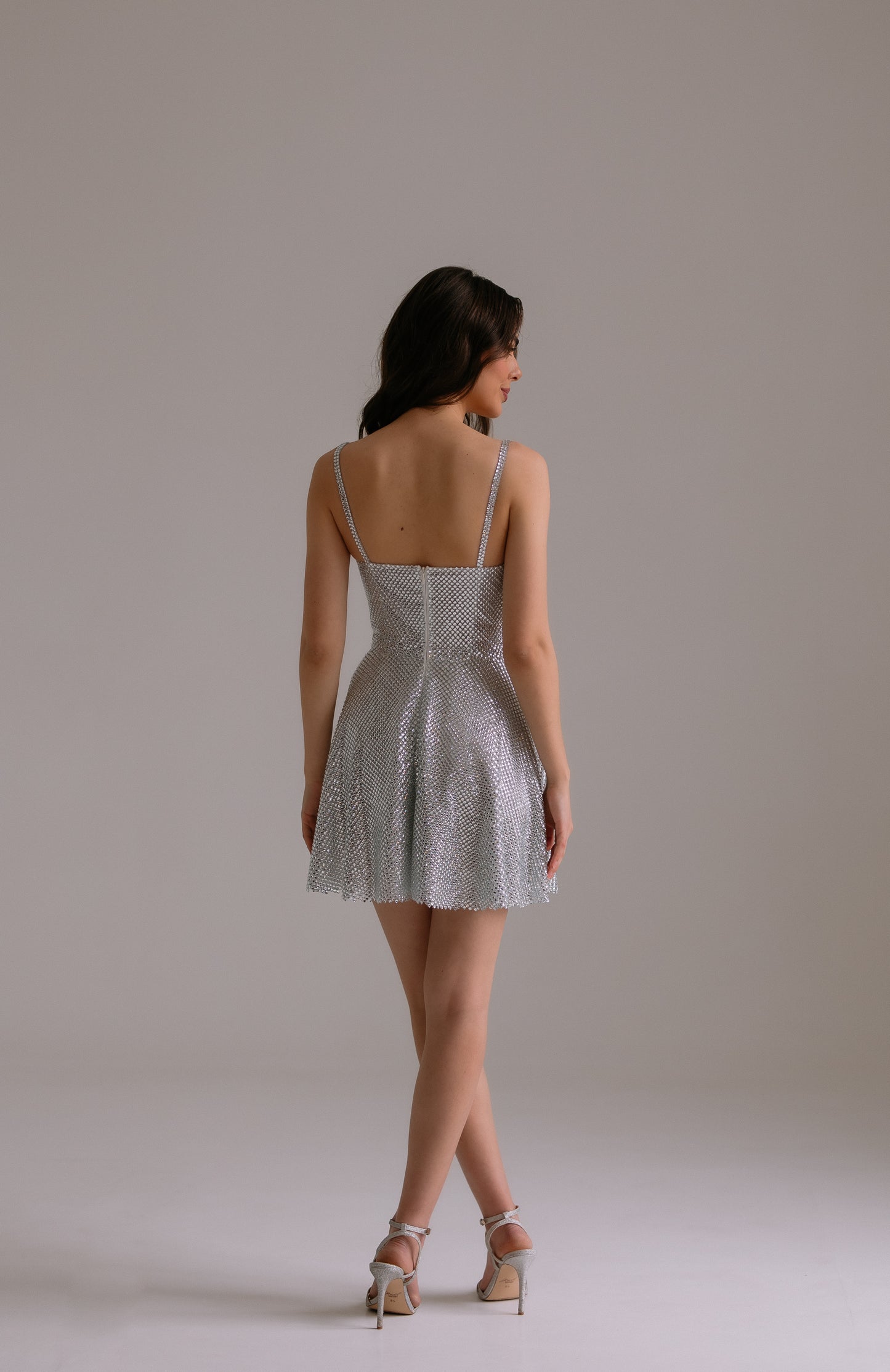 Aurora dress back view showing sparkling crystal details and elegant A-line silhouette
