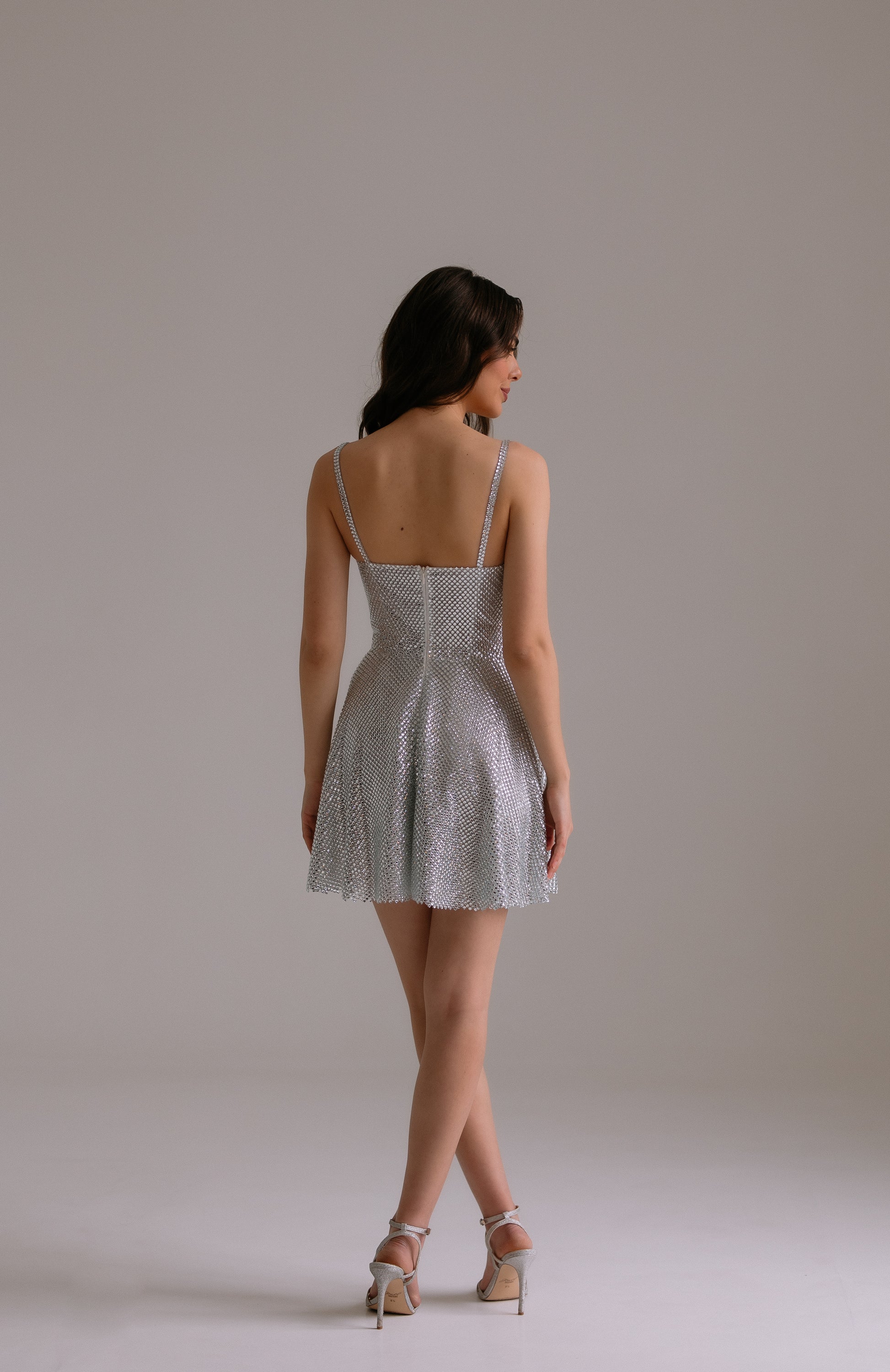 Aurora dress back view showing sparkling crystal details and elegant A-line silhouette
