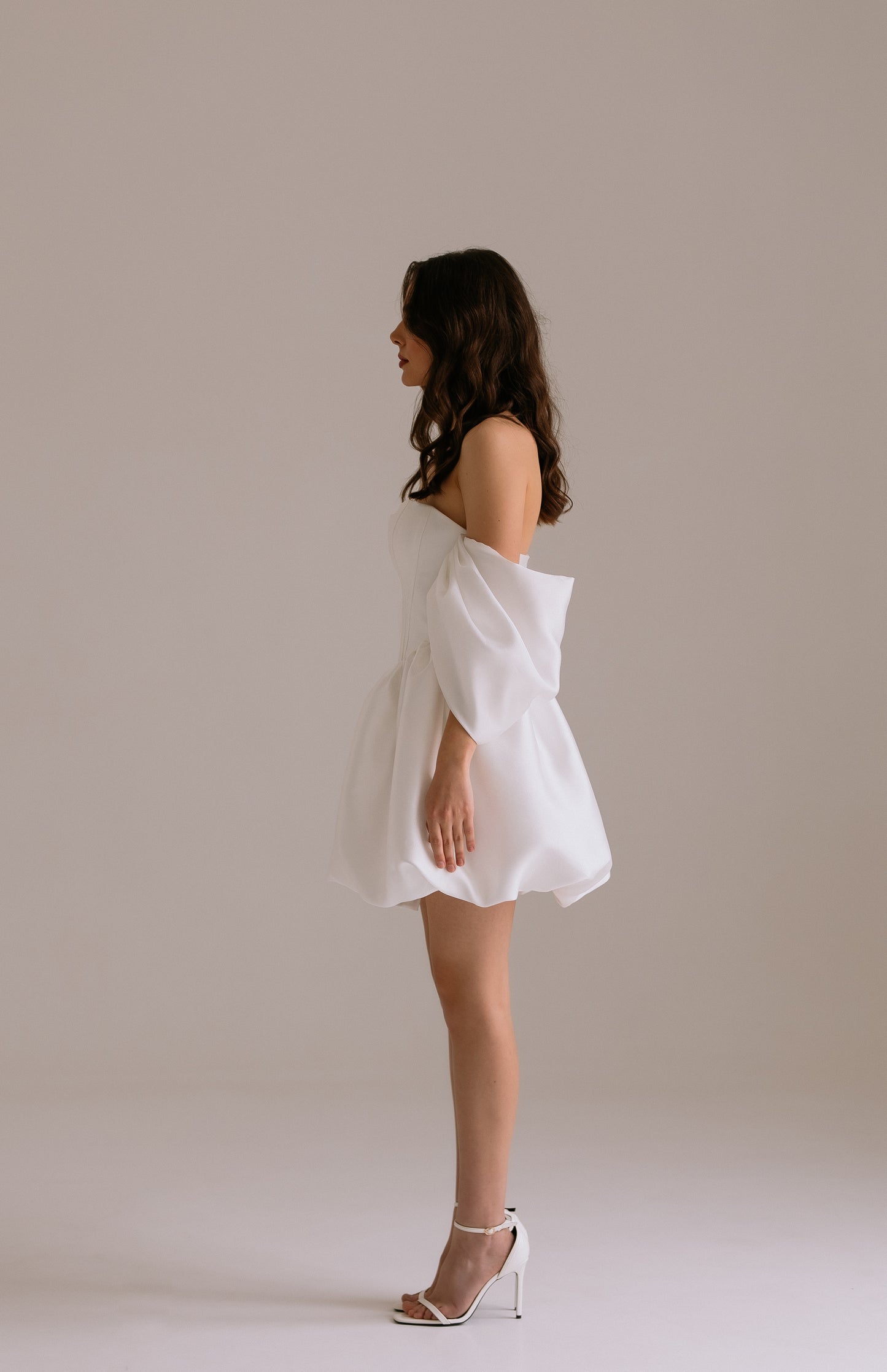 Bianca dress side view revealing dramatic drop waist silhouette,  voluminous skirt and voluminous off-shoulder sleeves
