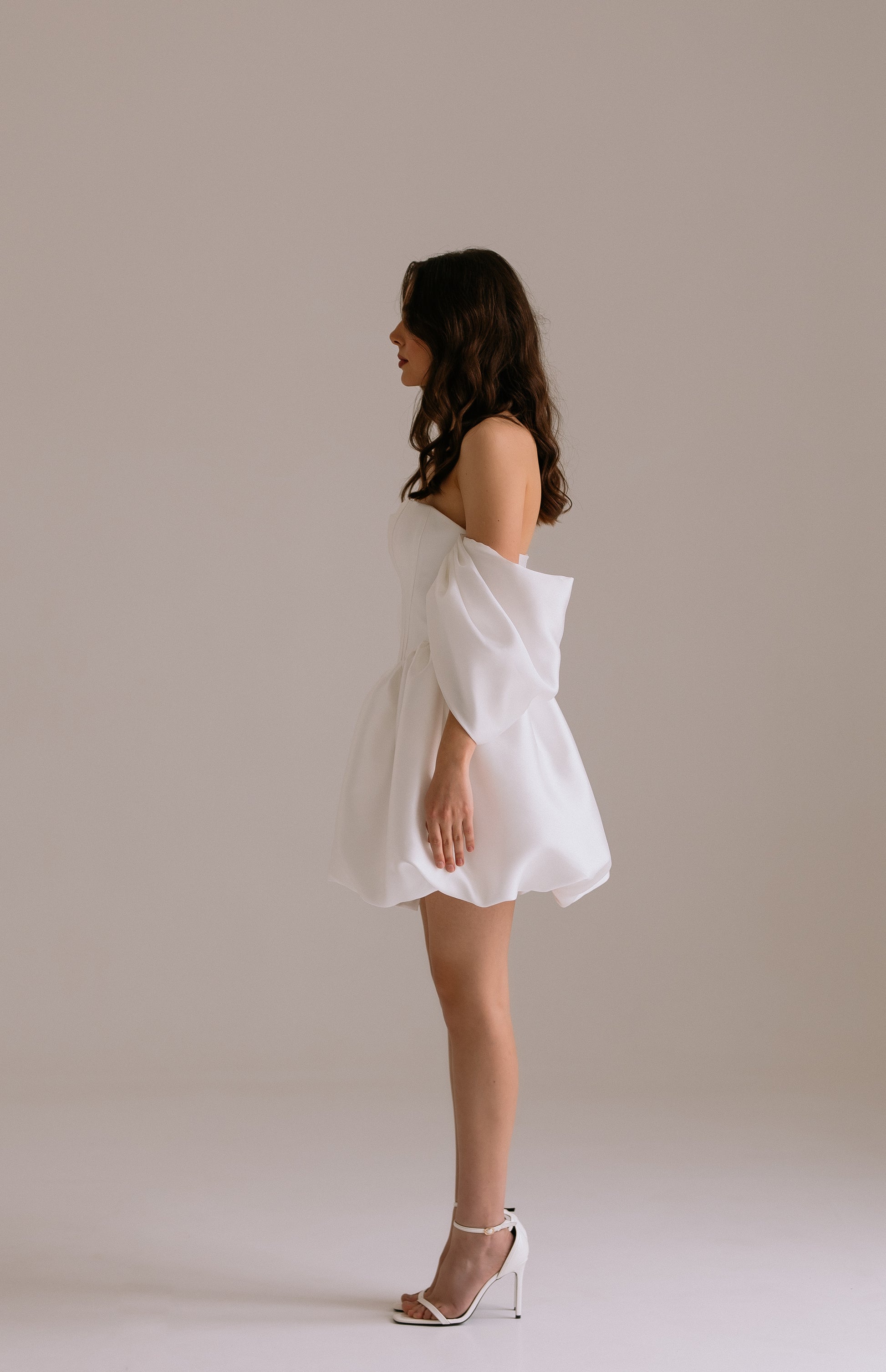 Bianca dress side view revealing dramatic drop waist silhouette,  voluminous skirt and voluminous off-shoulder sleeves
