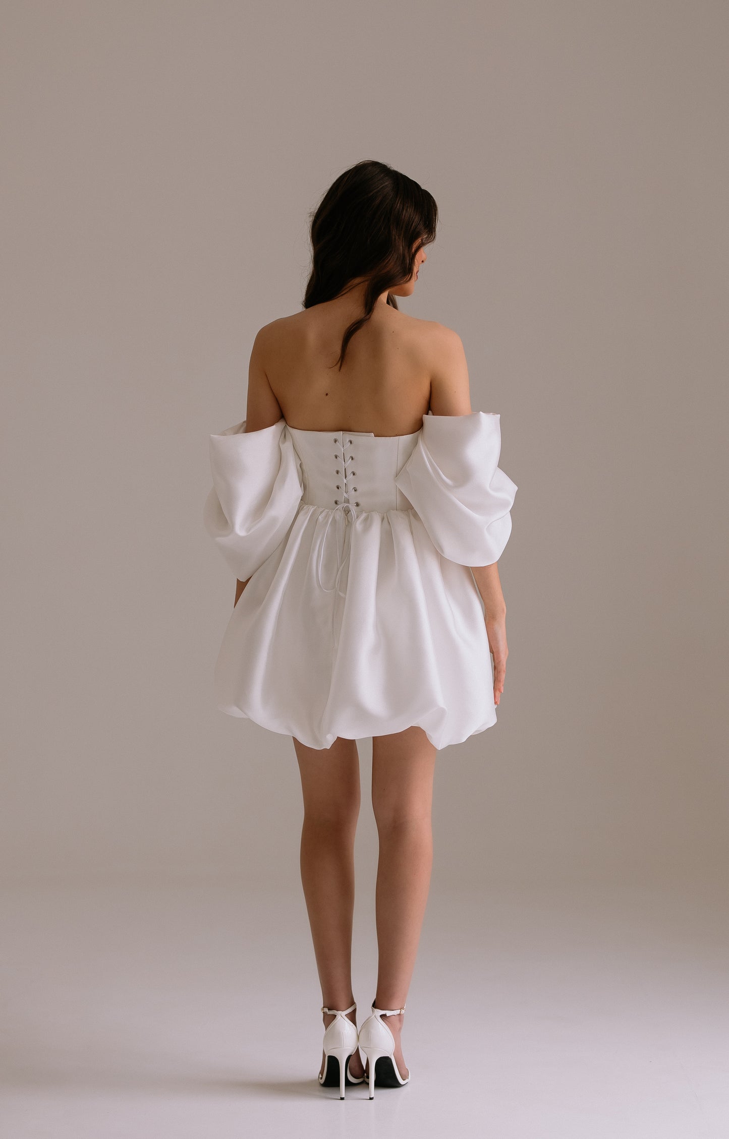 Bianca dress back view showing elegant drop waist design with voluminous off-shoulder sleeves and structured  skirt