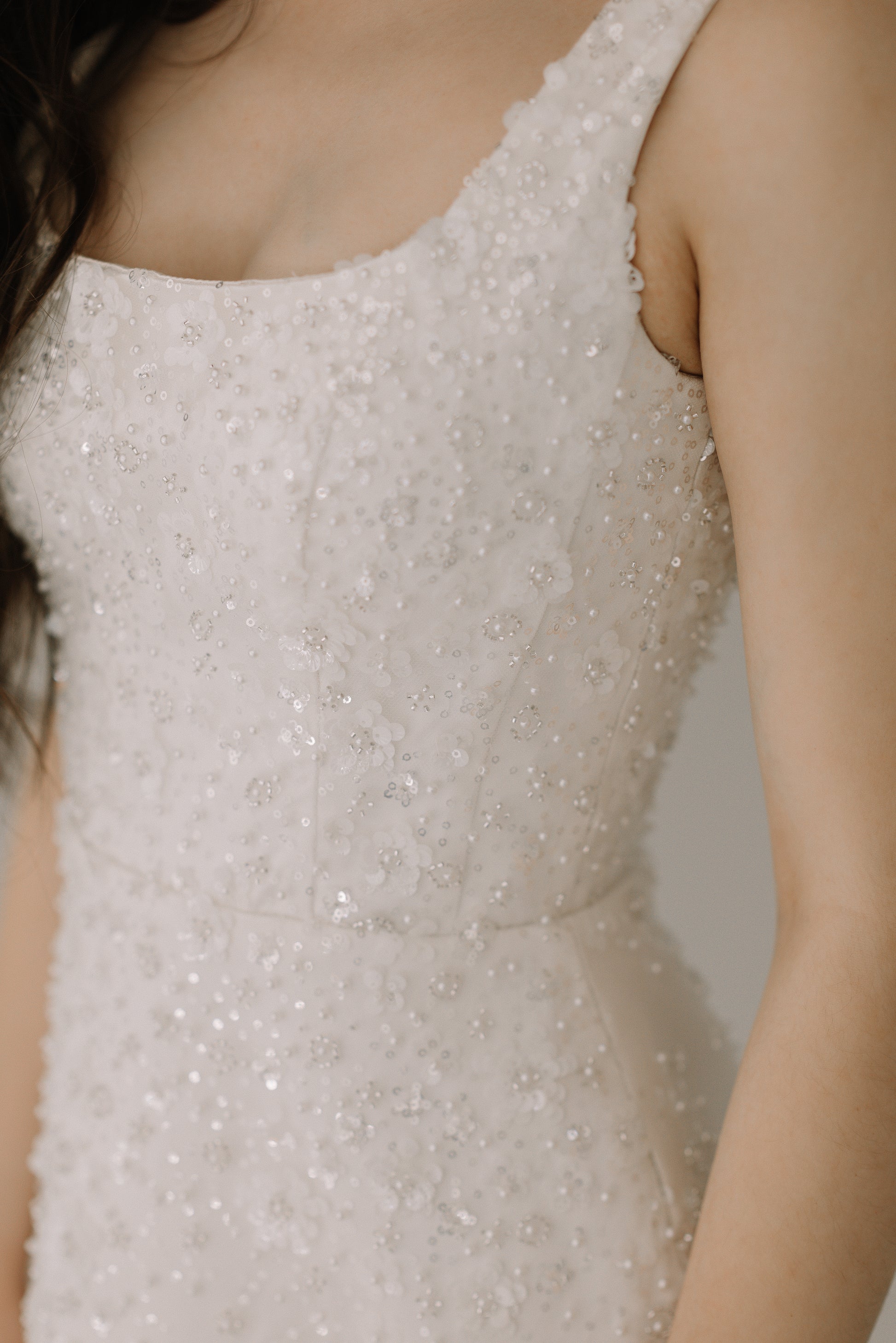Dalia dress detail showcasing delicate sequin flowers pearls and beading work
