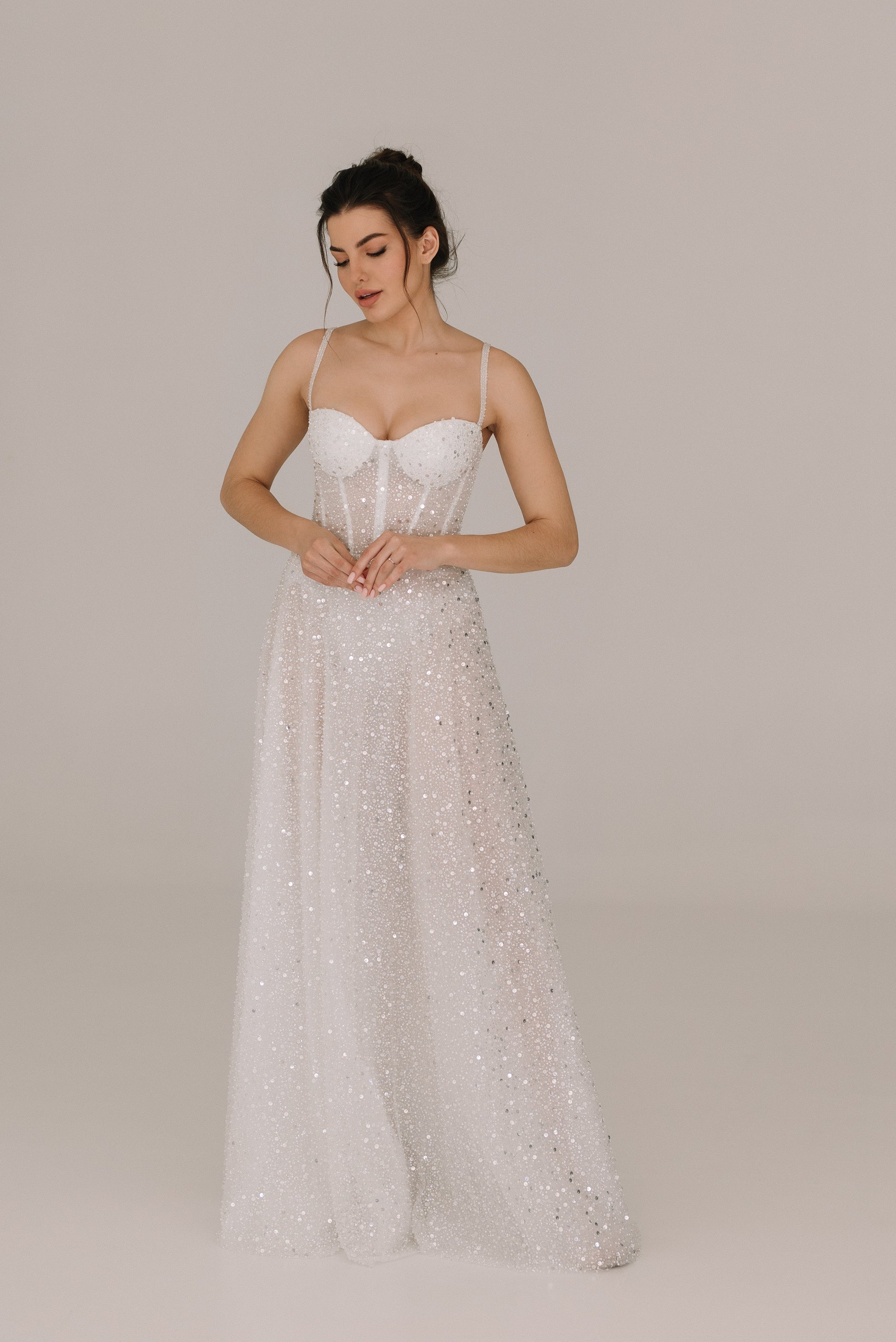 Celine White dress adorned with sequins pearls and beads featuring elegant belt and straps for bridal celebrations
