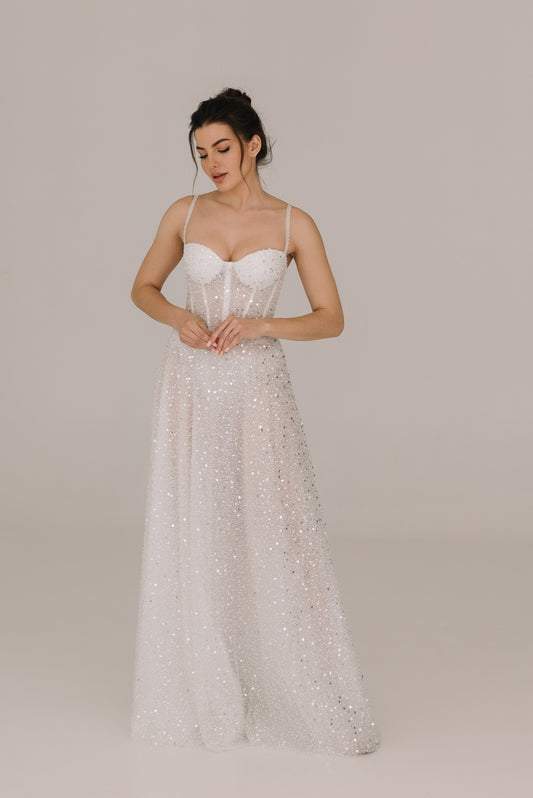 Celine White dress adorned with sequins pearls and beads featuring elegant belt and straps for bridal celebrations
